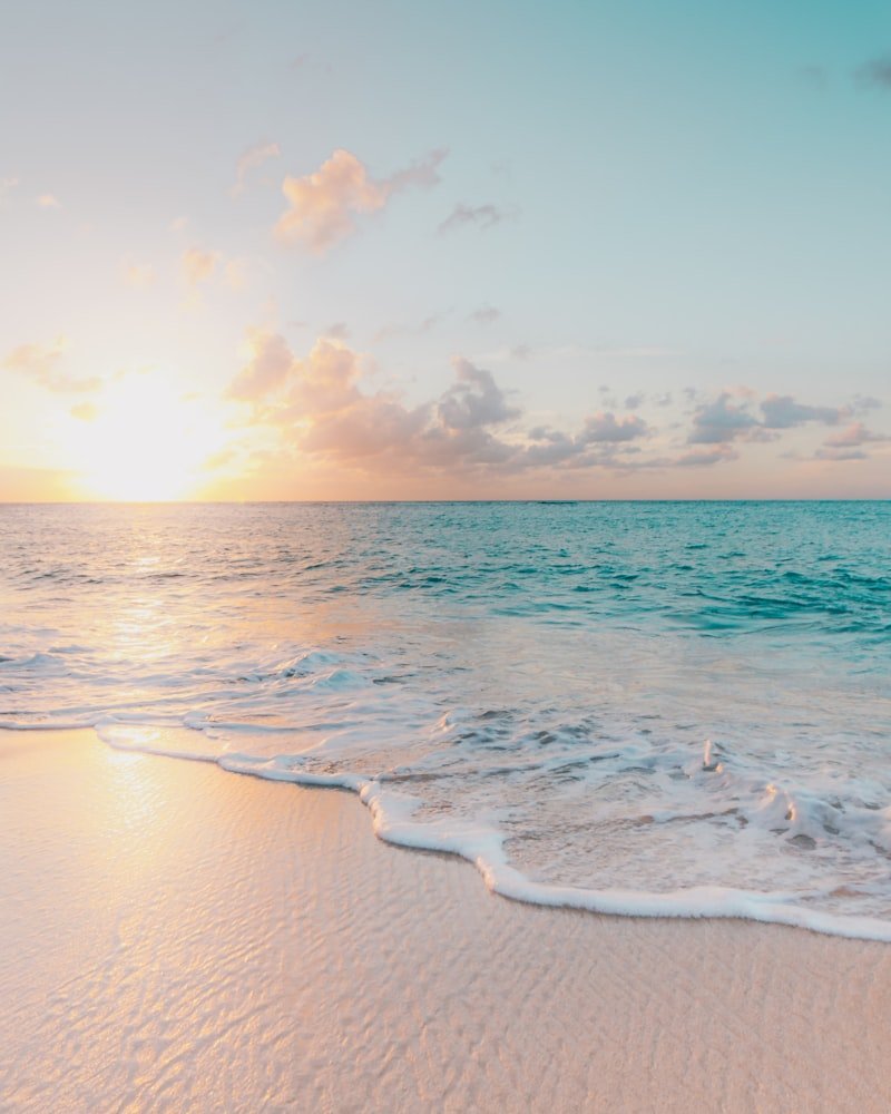 A quiet stretch of white sand meeting clear turquoise water