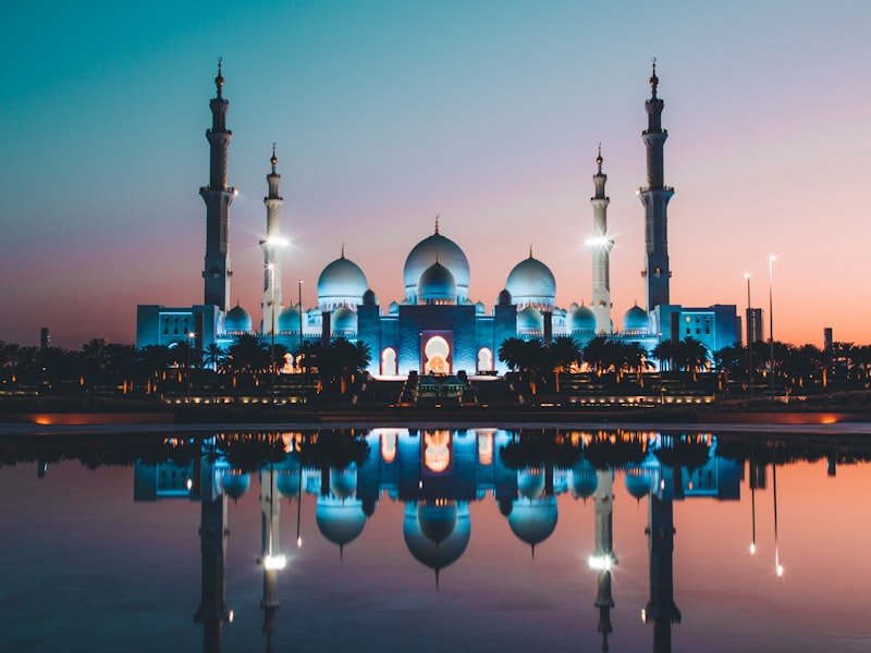 The white domes of a grand mosque at first light