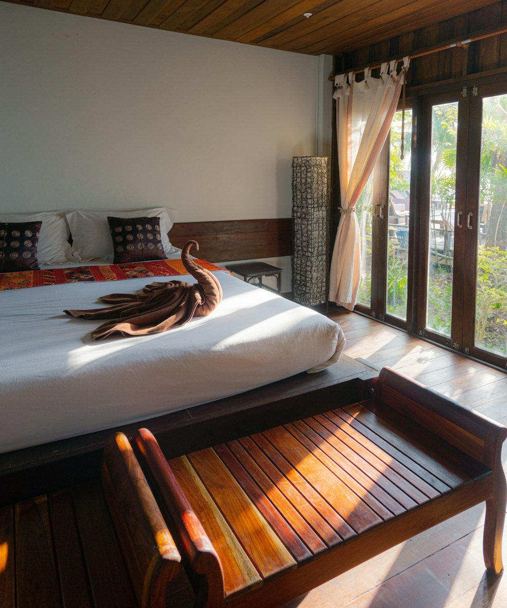 An architecturally striking boutique hotel pool surrounded by greenery